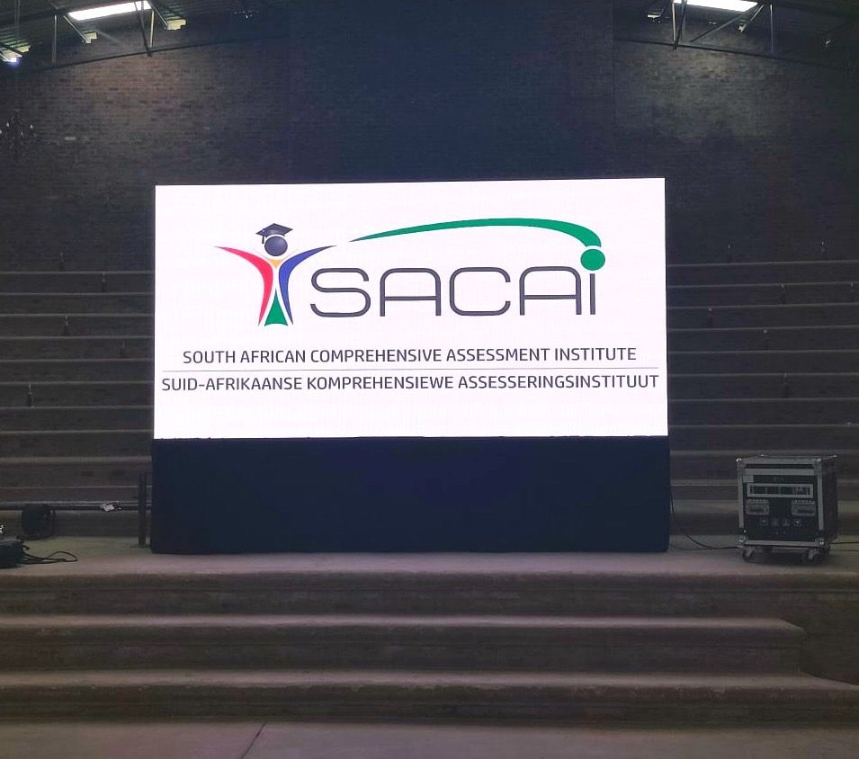 SACAI branding on an indoor LED wall
